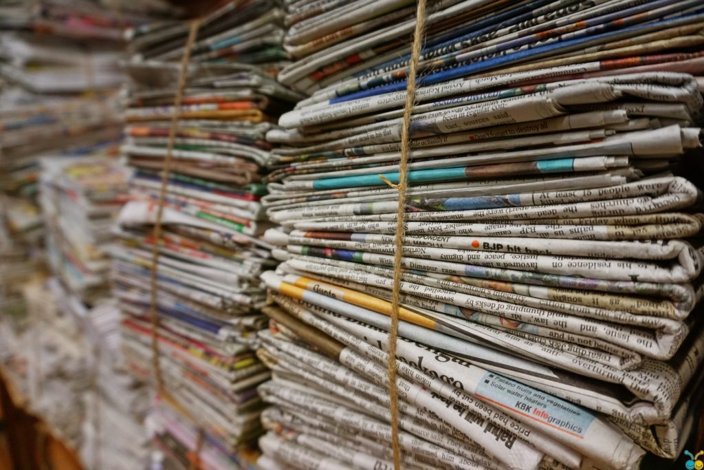 A photo of newspapers bundled together, published to 